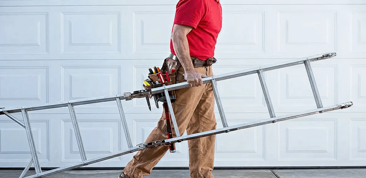 Garage door repair technician arriving with tools and ladder in Phoenix, AZ