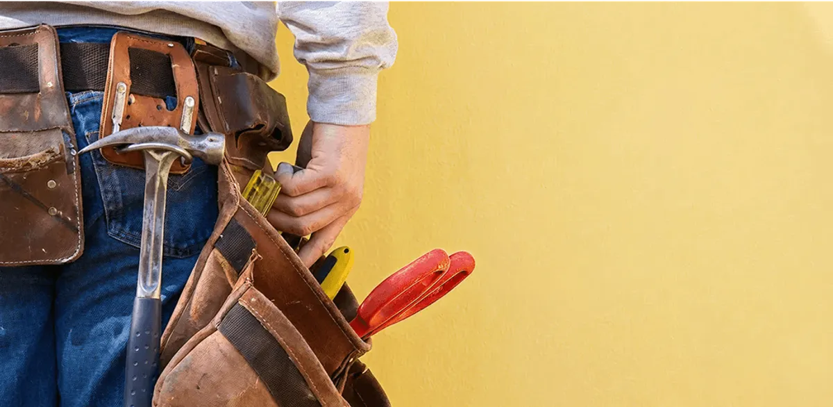 Handyman with tool belt ready for home repairs and maintenance in Phoenix, AZ